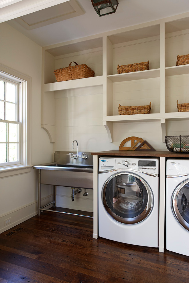 Laundry room - traditional laundry room idea in Other with wood countertops and brown countertops