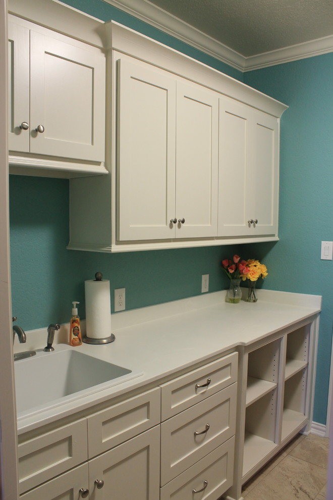 Mid-sized elegant galley ceramic tile dedicated laundry room photo in Austin with a single-bowl sink, white cabinets, marble countertops, blue walls and a side-by-side washer/dryer