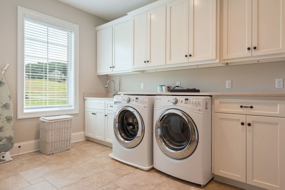 This is an example of a large classic single-wall separated utility room in Other with a submerged sink, shaker cabinets, white cabinets, granite worktops, beige walls, travertine flooring, a side by side washer and dryer and beige floors.