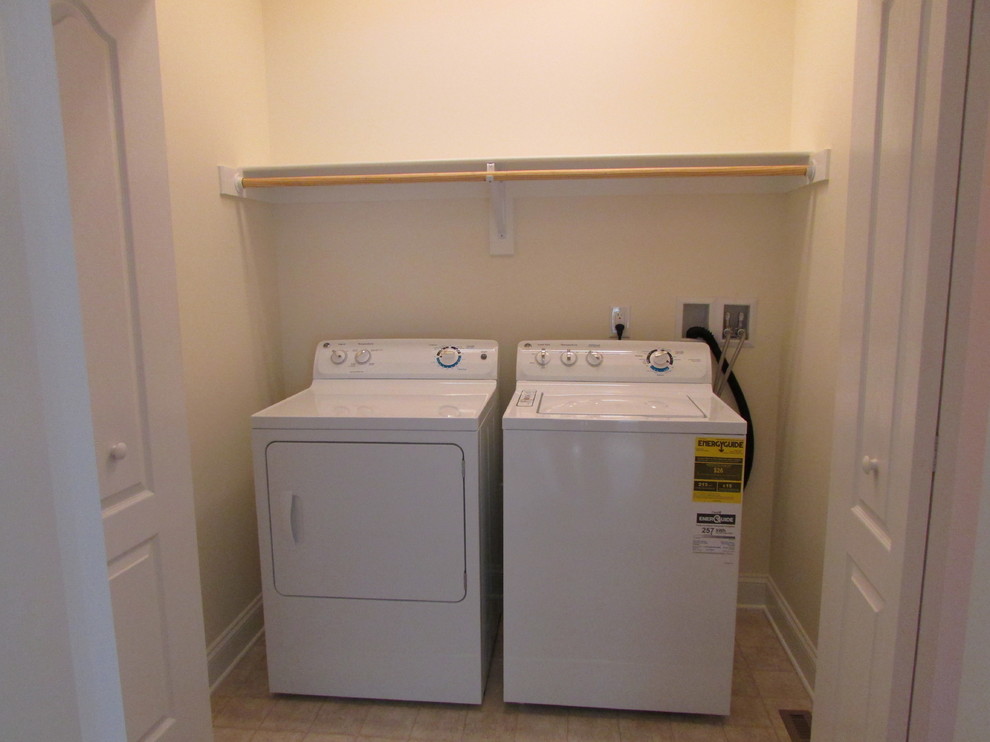 Laundry closet - small traditional single-wall vinyl floor laundry closet idea in Other with beige walls and a side-by-side washer/dryer