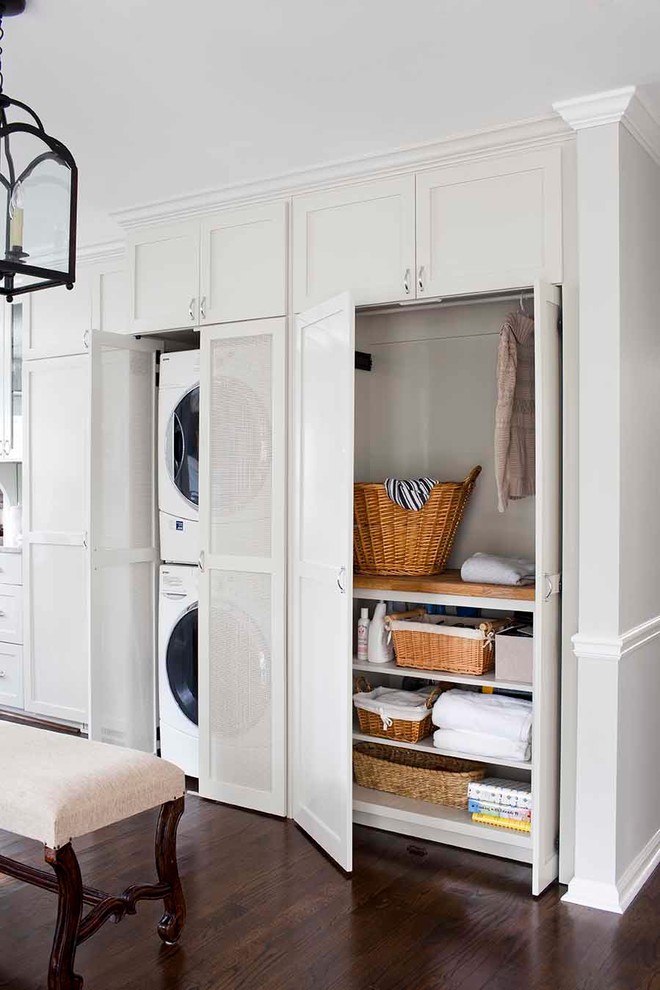Inspiration for a mid-sized transitional medium tone wood floor laundry room remodel in Atlanta with shaker cabinets, gray cabinets, white backsplash, subway tile backsplash and wood countertops