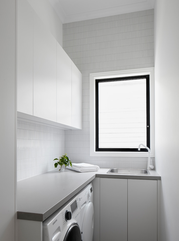 Design ideas for a small contemporary l-shaped utility room in Melbourne with a single-bowl sink, beaded cabinets, composite countertops, a side by side washer and dryer and beige worktops.