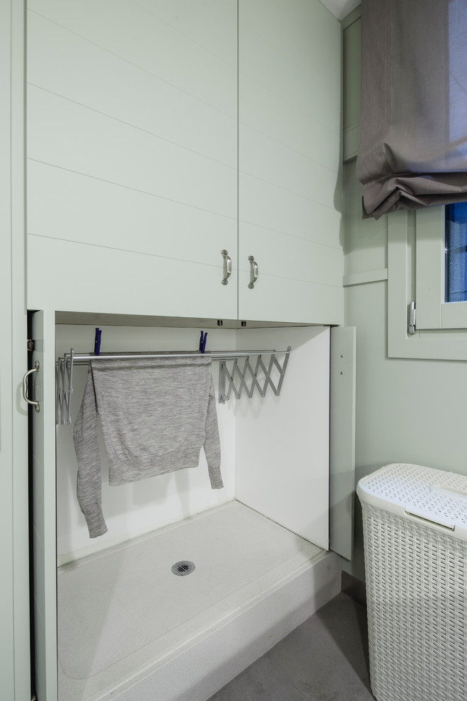 Photo of a small classic utility room in Barcelona with flat-panel cabinets.