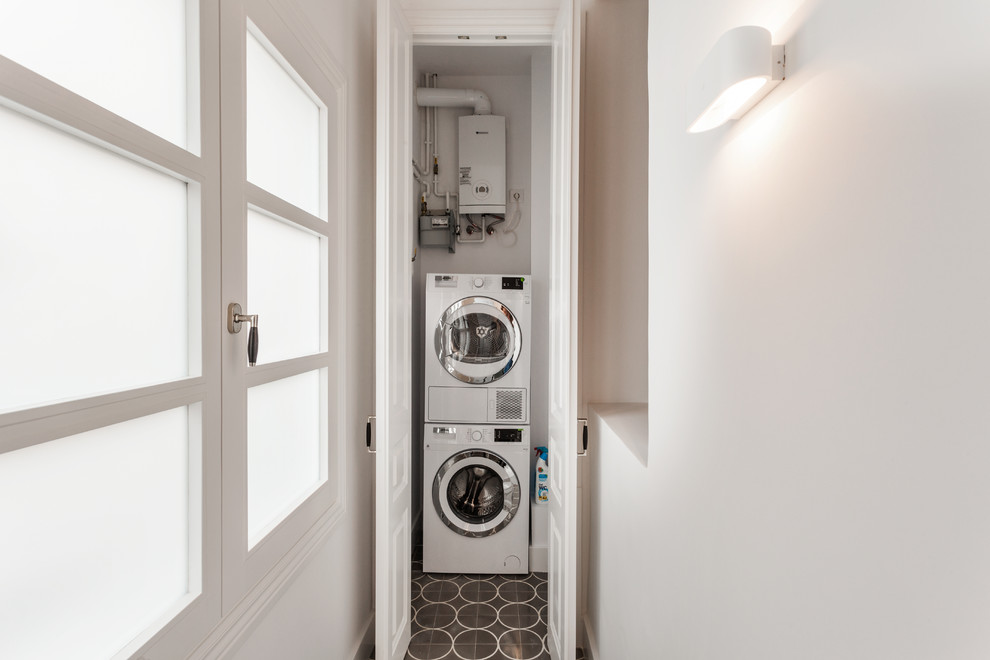 Imagen de lavadero clásico renovado pequeño con lavadora y secadora apiladas