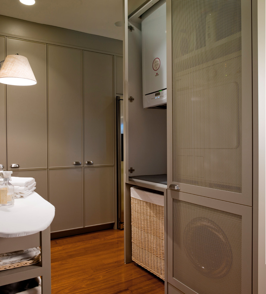 Example of an eclectic laundry room design in Barcelona with gray cabinets
