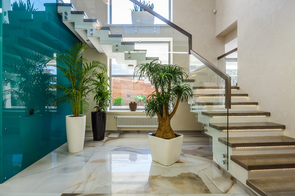 На фото: угловая бетонная лестница среднего размера в современном стиле с деревянными ступенями с