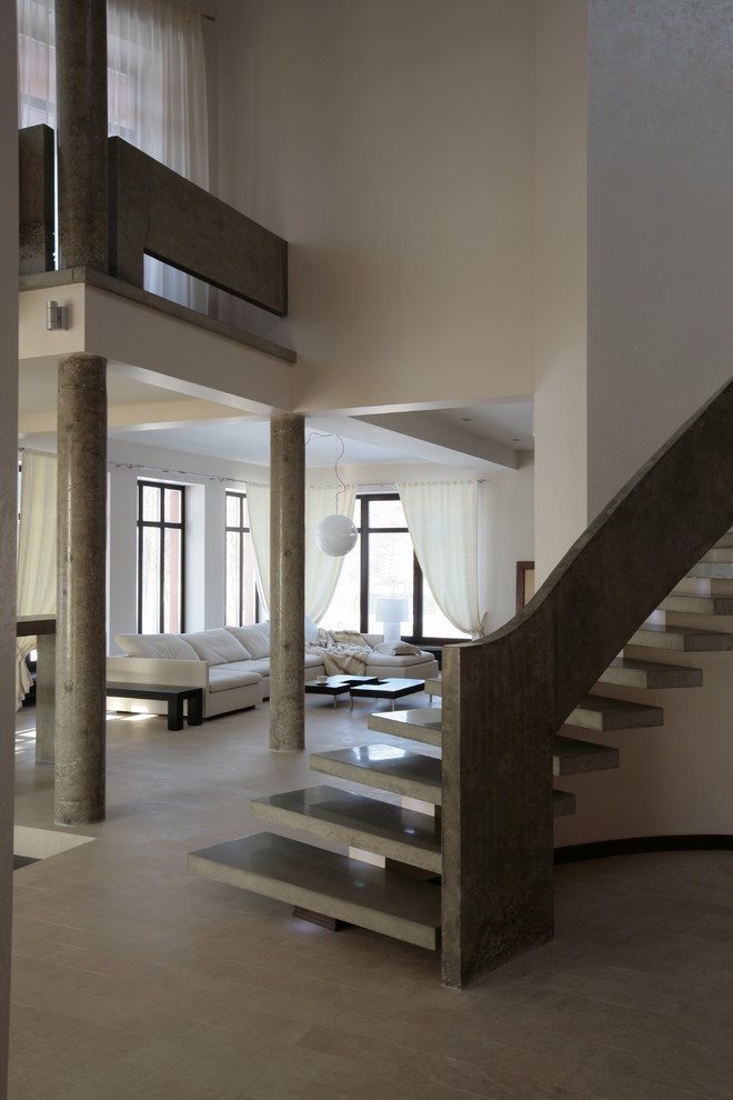 Пример оригинального дизайна: маленькая изогнутая лестница в современном стиле с бетонными ступенями без подступенок для на участке и в саду