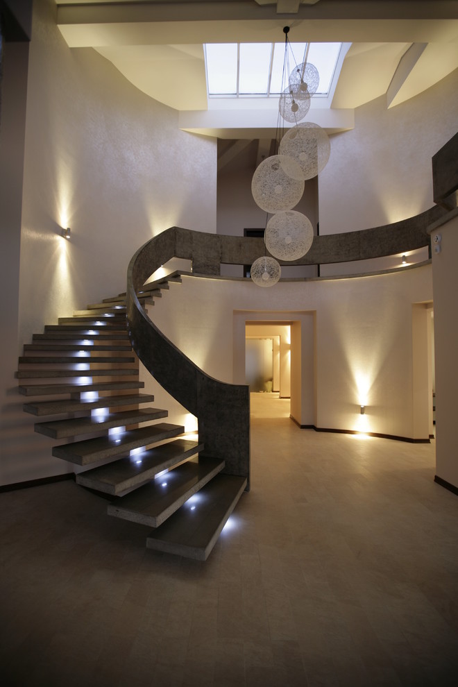 Design ideas for a small contemporary concrete curved staircase in Moscow with open risers.