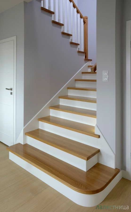 Cette image montre un escalier nordique en U de taille moyenne avec des marches en bois, des contremarches en bois, un garde-corps en bois et du papier peint.