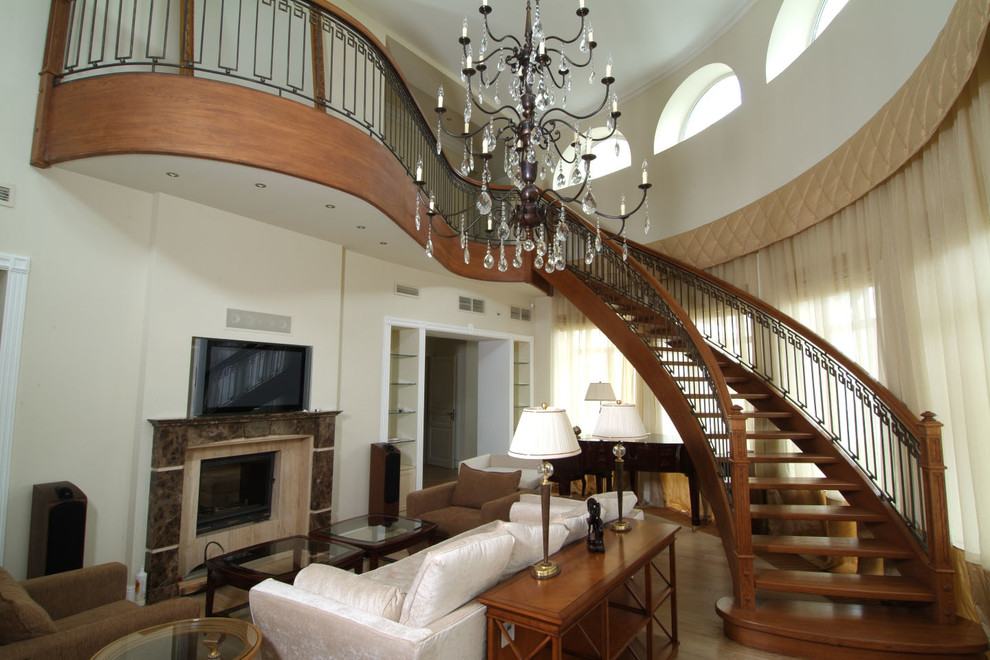 This is an example of a large classic wood curved mixed railing staircase in Moscow.