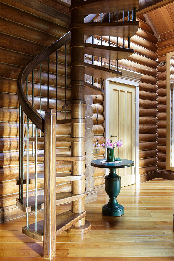 Farmhouse wood spiral mixed railing staircase in Moscow with open risers.