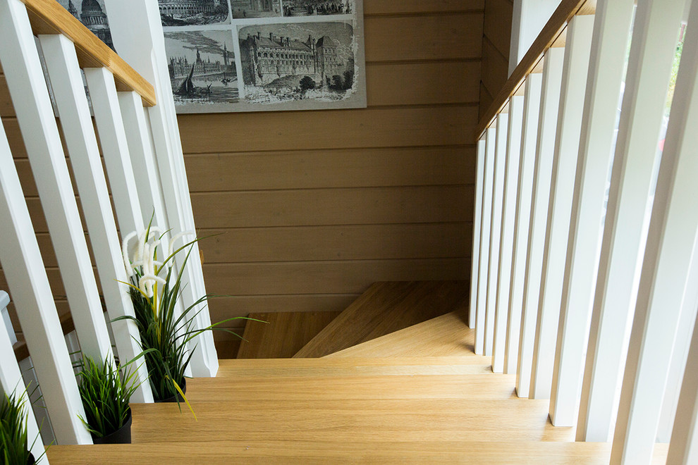 Design ideas for a rural wood curved staircase in Moscow with open risers.