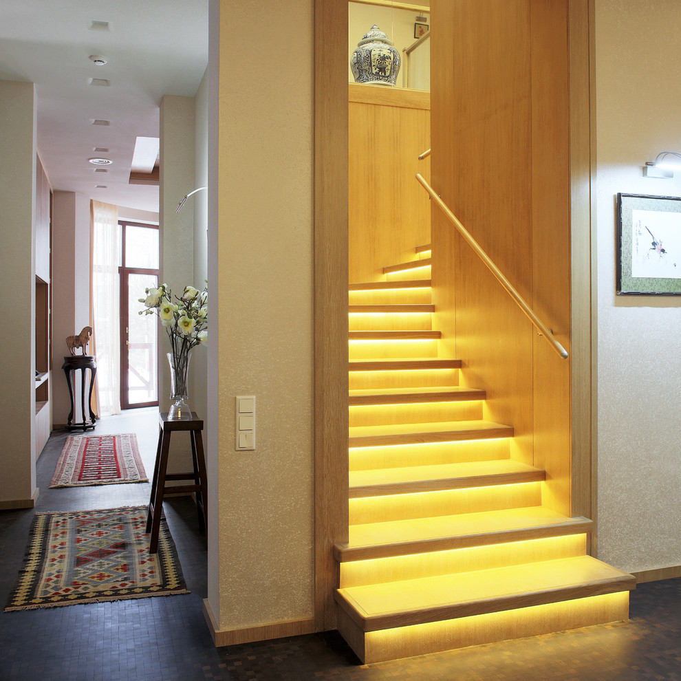 Photo of a contemporary wood l-shaped staircase in Moscow with wood risers.