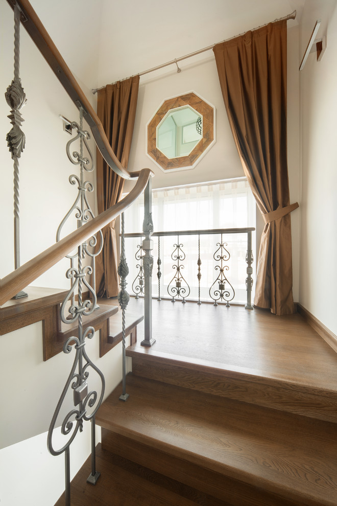 Contemporary wood u-shaped mixed railing staircase in Moscow with wood risers.