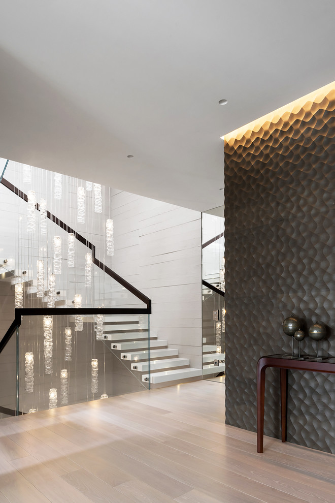 This is an example of a contemporary floating glass railing staircase in Moscow with open risers.