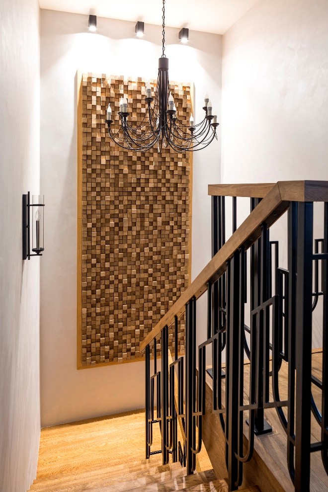 Ejemplo de escalera en U contemporánea con escalones de madera y barandilla de varios materiales