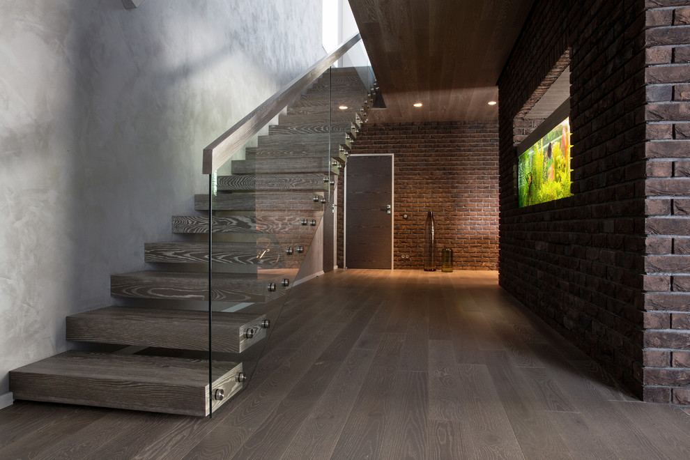 Design ideas for an expansive contemporary straight glass railing staircase in Other with open risers.