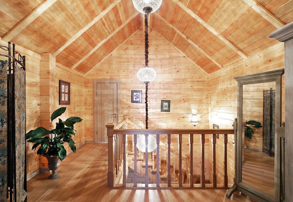 Ejemplo de escalera en U de estilo de casa de campo grande con escalones de madera, contrahuellas de madera y barandilla de madera
