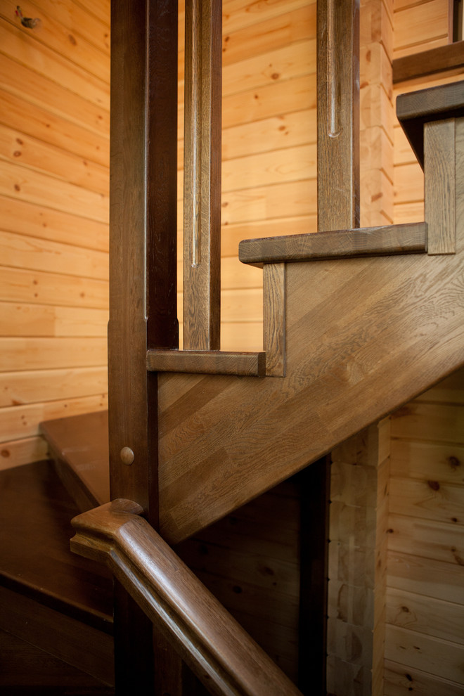 Design ideas for a medium sized rural wood u-shaped wood railing staircase in Moscow with wood risers.