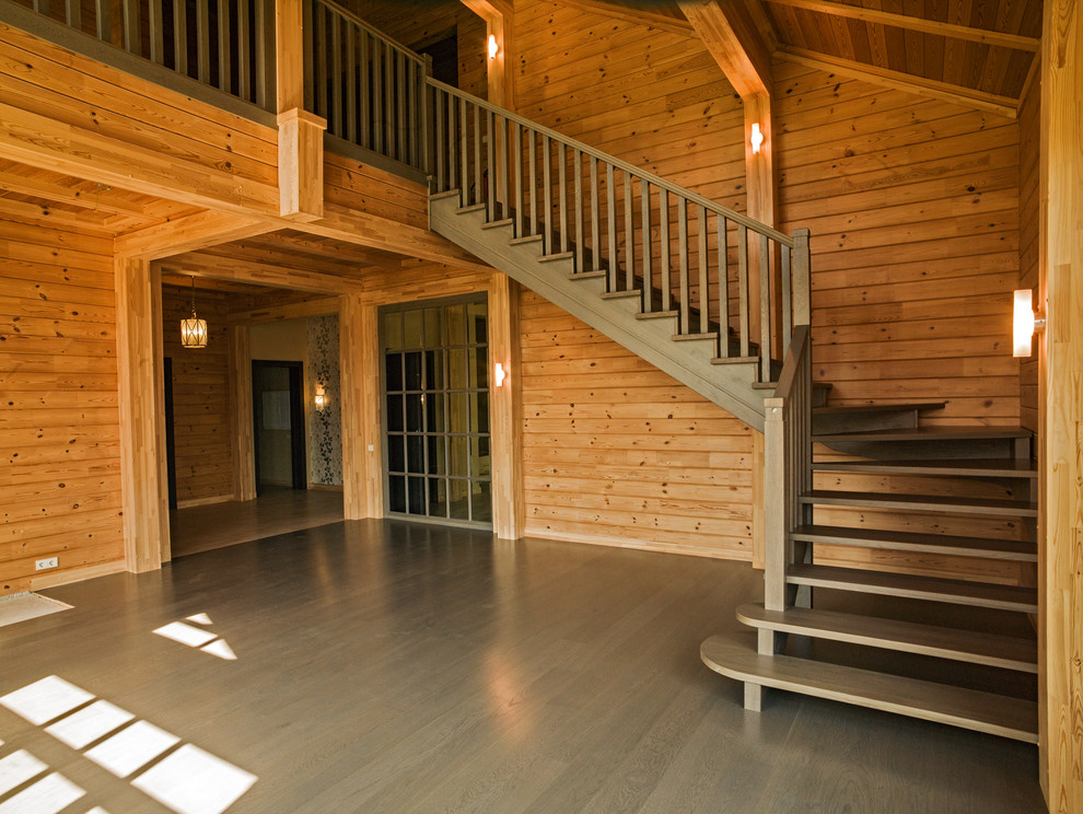 Ejemplo de escalera en L campestre de tamaño medio con escalones de madera, contrahuellas de madera y barandilla de madera