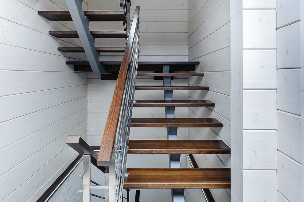 Diseño de escalera en U urbana de tamaño medio sin contrahuella con escalones de madera, barandilla de metal y madera