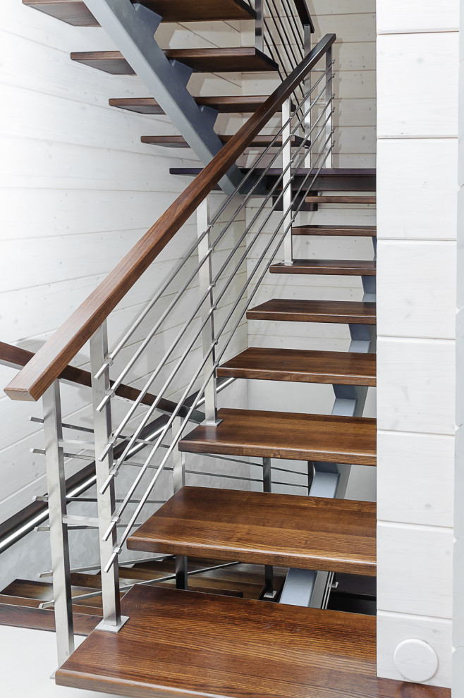 Réalisation d'un escalier sans contremarche urbain en U et bois de taille moyenne avec des marches en bois et un garde-corps en métal.