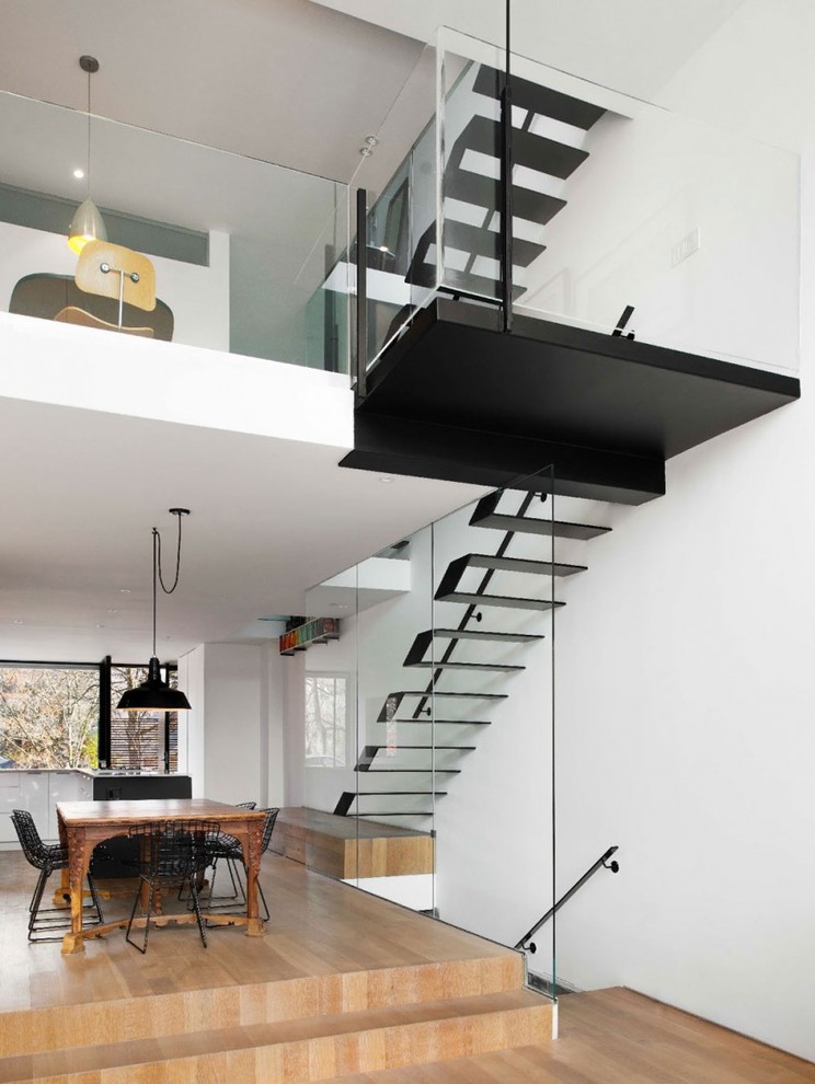 This is an example of a contemporary glass u-shaped staircase in Moscow with open risers.