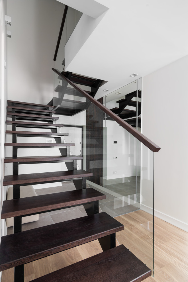 Mid-sized trendy wooden straight open and glass railing staircase photo in Moscow