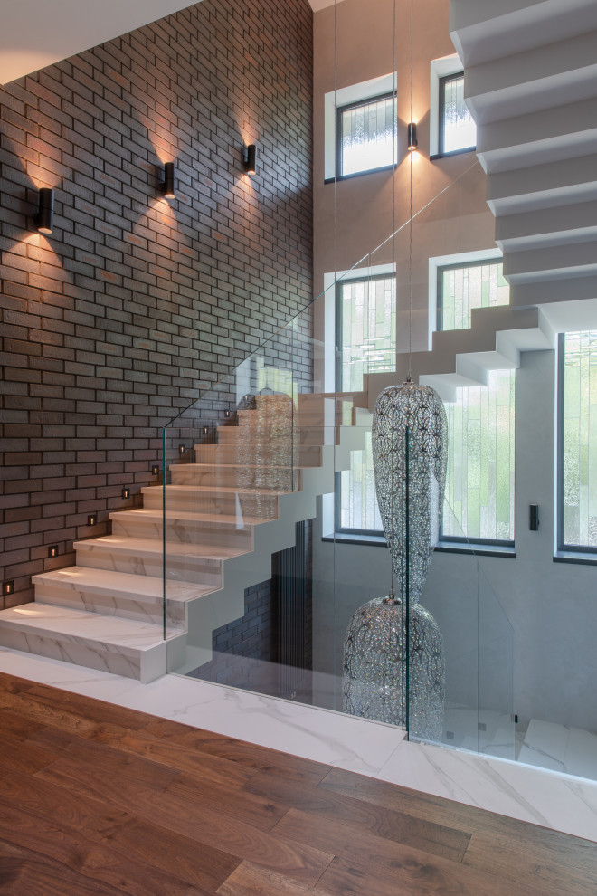 This is an example of a contemporary u-shaped glass railing staircase in Other.