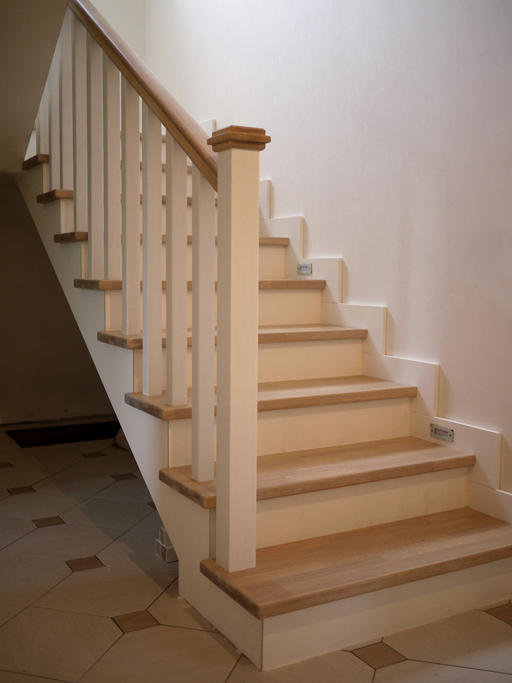 Design ideas for a medium sized scandi wood u-shaped staircase in Moscow with wood risers.