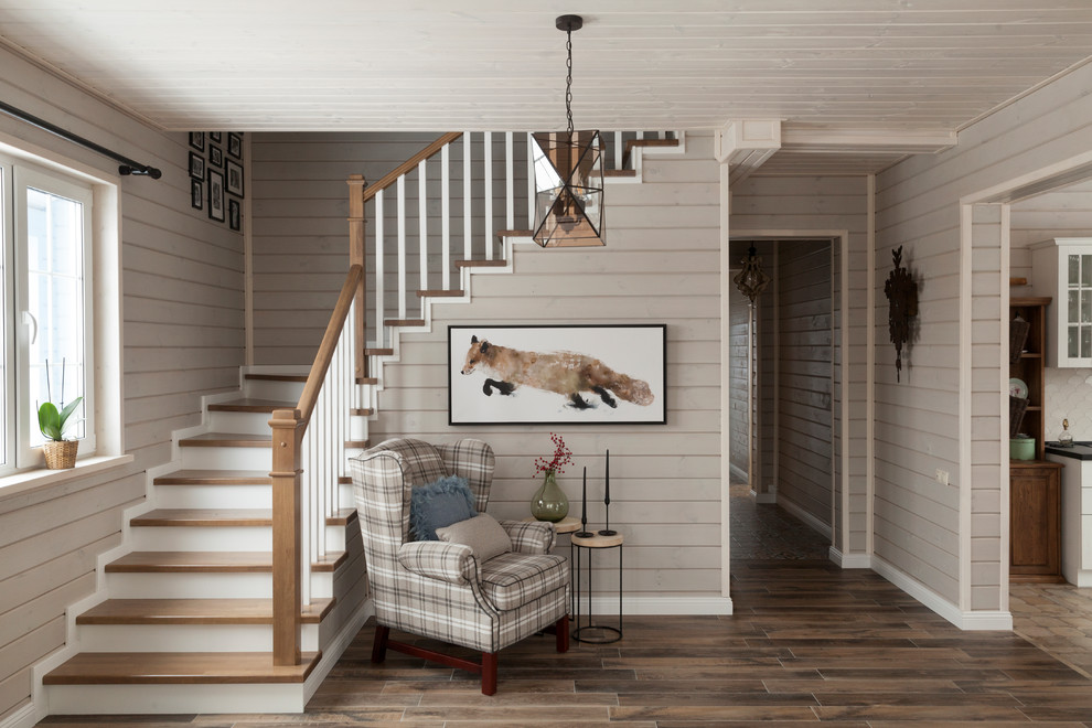 Inspiration pour un escalier nordique en L avec des marches en bois et un garde-corps en bois.
