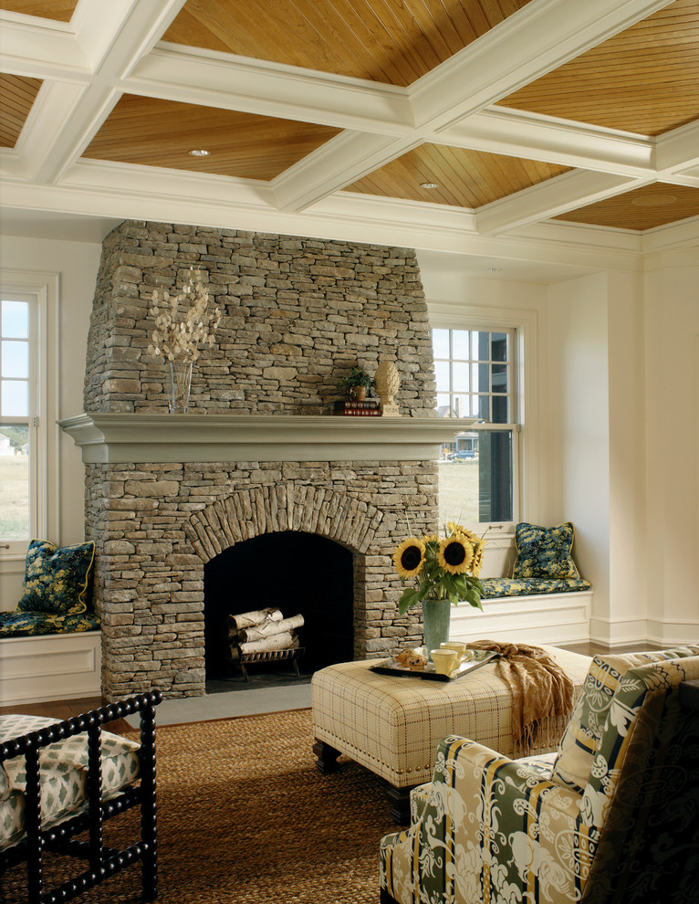 Example of a large classic enclosed medium tone wood floor living room design in Providence with white walls, a standard fireplace, a stone fireplace and no tv
