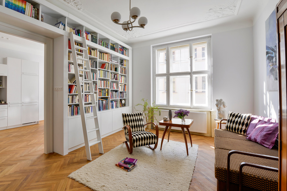Inspiration for a mid-sized timeless enclosed light wood floor living room library remodel in Other with no fireplace, gray walls and no tv