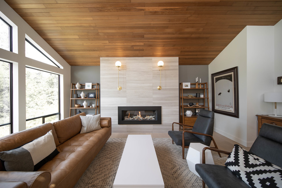 Example of a large trendy formal and open concept light wood floor and beige floor living room design in Vancouver with white walls, a ribbon fireplace, a tile fireplace and no tv
