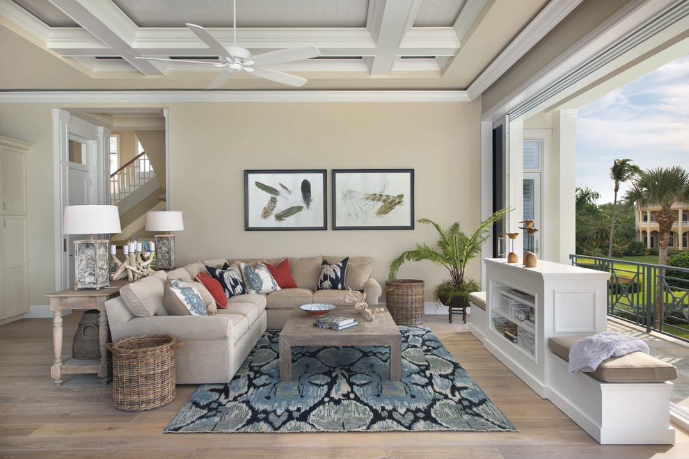 Design ideas for a coastal living room in Miami with feature lighting.