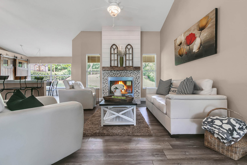 Living room - mid-sized country open concept laminate floor and gray floor living room idea in Orlando with gray walls, a standard fireplace and a tile fireplace