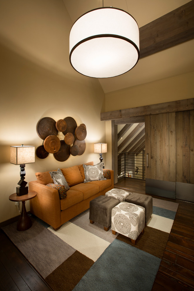 Inspiration for a rustic living room in Sacramento with beige walls and dark hardwood flooring.