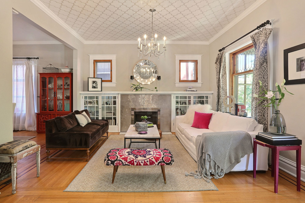 Living room - mid-sized transitional open concept medium tone wood floor living room idea in Denver with gray walls, a standard fireplace and a tile fireplace