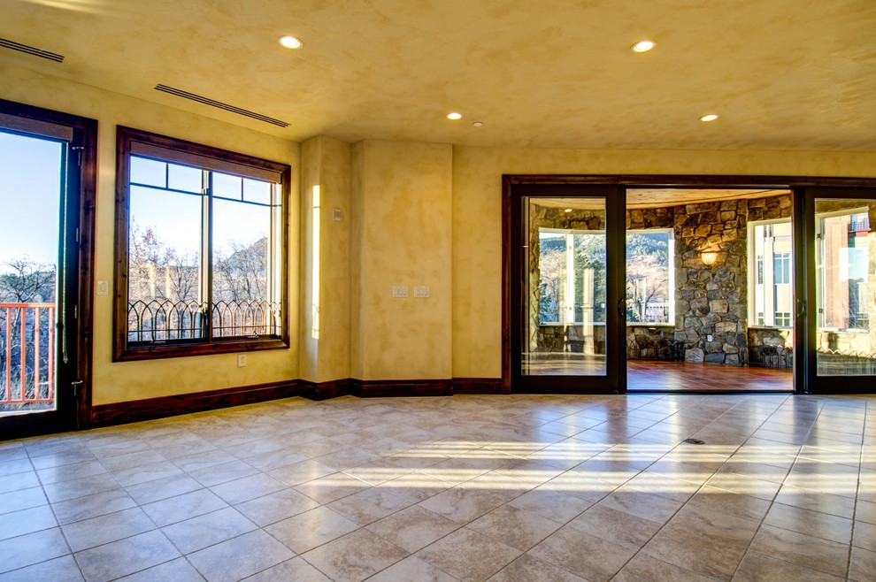 Photo of a medium sized mediterranean enclosed living room in Salt Lake City with yellow walls and ceramic flooring.