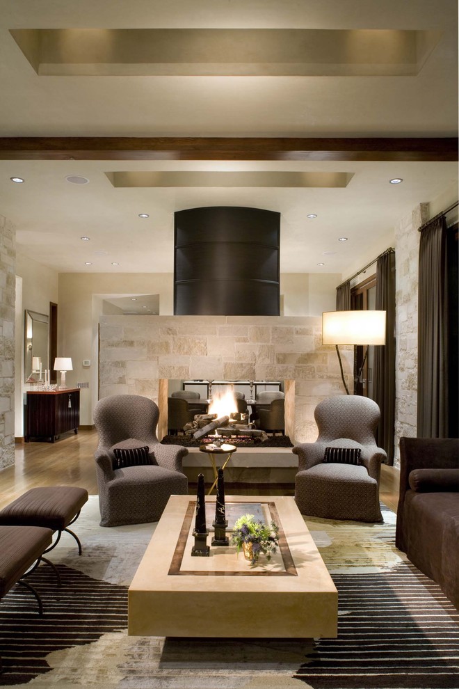 Example of a mid-century modern living room design in Denver with a two-sided fireplace