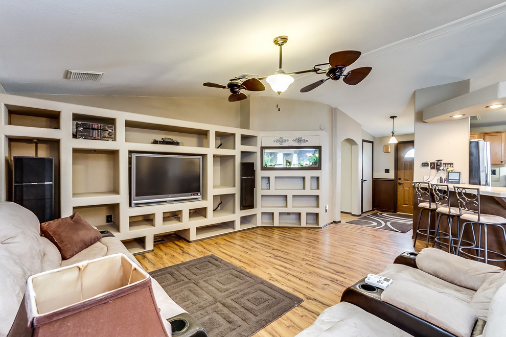 Photo of a large traditional open plan living room in Phoenix with beige walls, light hardwood flooring, no fireplace and a built-in media unit.