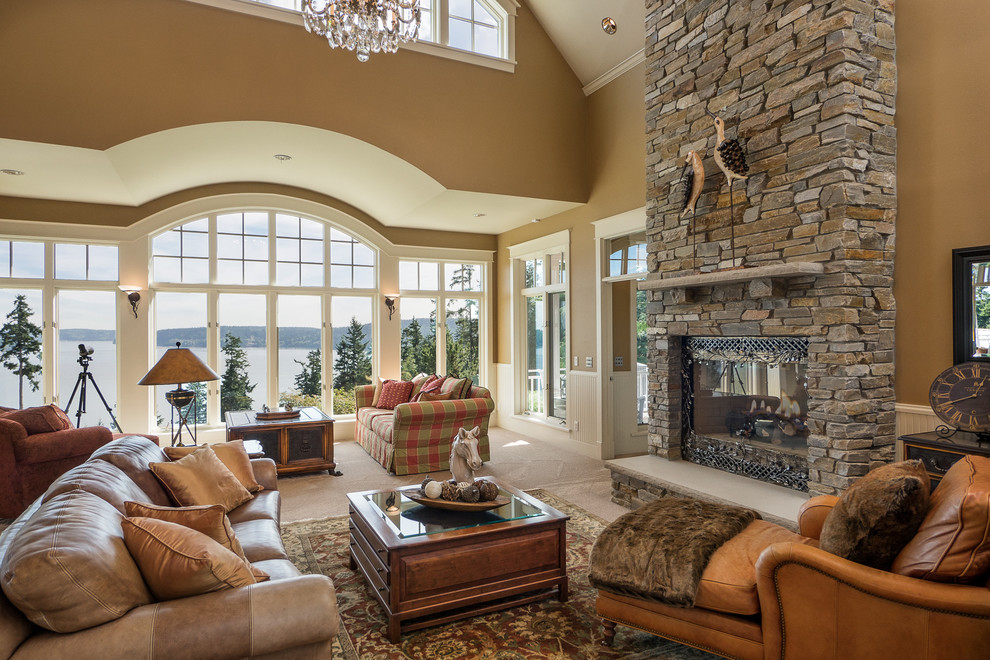 Inspiration for a classic open plan living room in Seattle with brown walls, a standard fireplace, a stone fireplace surround and feature lighting.