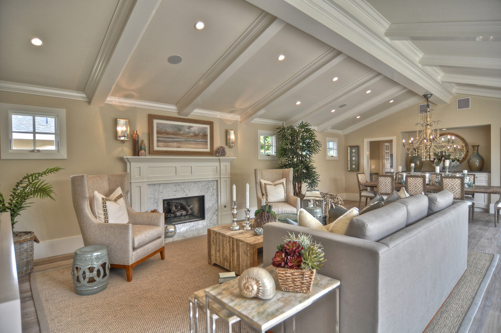 Example of a beach style living room design in Los Angeles with beige walls and a standard fireplace