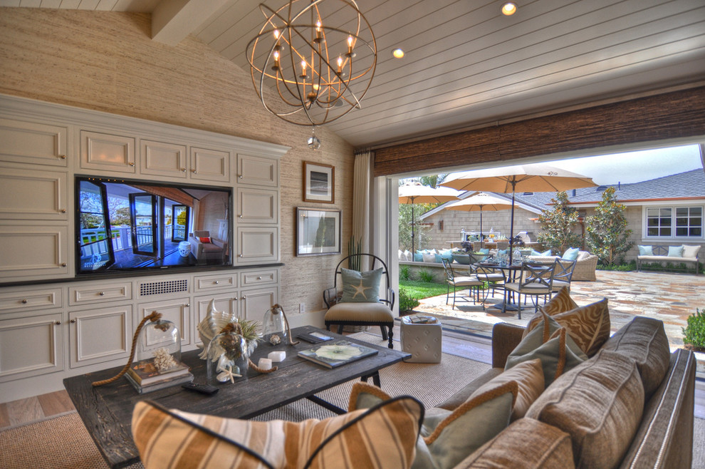 Inspiration for a coastal living room remodel in Los Angeles with beige walls and a media wall