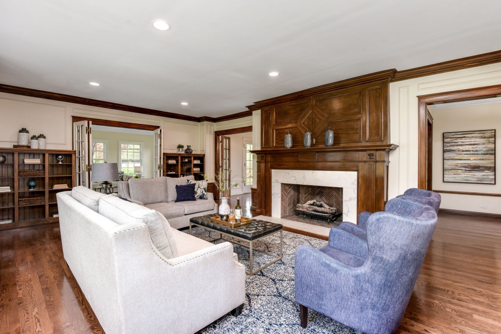 Inspiration for a timeless enclosed dark wood floor, brown floor and wall paneling living room remodel in Detroit with white walls and a standard fireplace