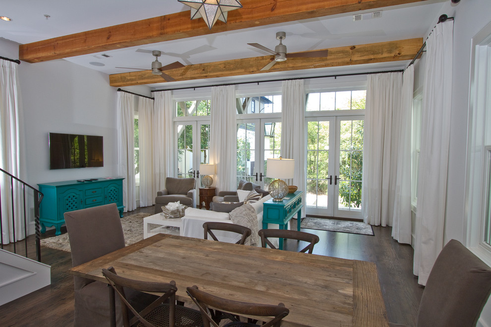 Example of a mid-sized beach style open concept medium tone wood floor living room design in Miami with yellow walls, no fireplace and a wall-mounted tv