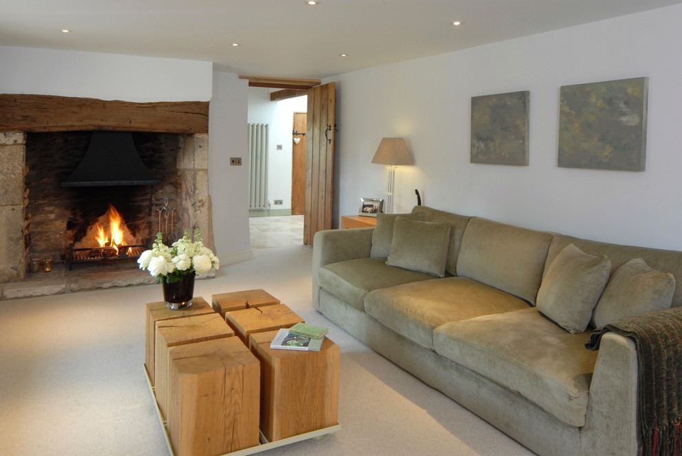 Design ideas for a medium sized contemporary open plan living room in Oxfordshire with a reading nook, white walls, carpet, a standard fireplace, a stone fireplace surround and a wall mounted tv.