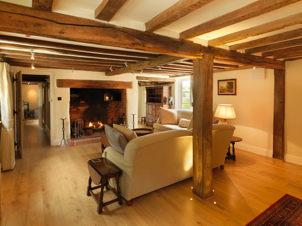 Large farmhouse formal and open concept light wood floor living room photo in Hampshire with beige walls