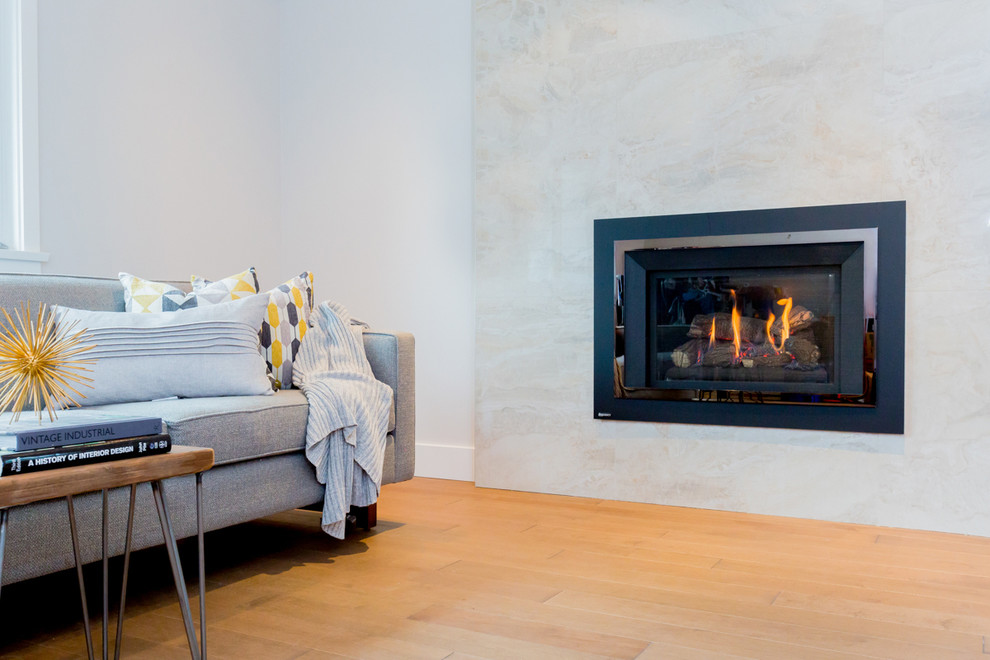 Inspiration for an expansive modern open plan living room in Vancouver with grey walls, medium hardwood flooring, a standard fireplace, a tiled fireplace surround and no tv.
