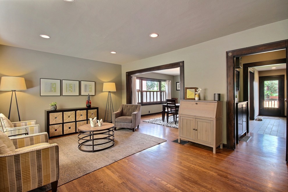 Example of a mid-sized arts and crafts formal and open concept medium tone wood floor and brown floor living room design in Portland with no fireplace, no tv and green walls